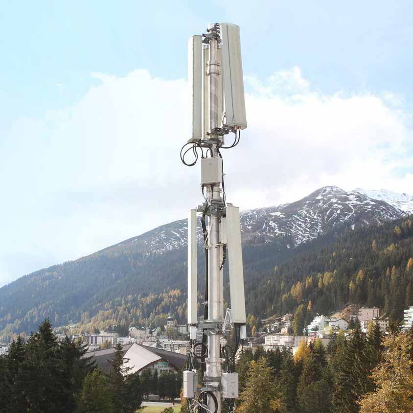 Infravista - A cell tower in front of a mountain with mountains in the background.